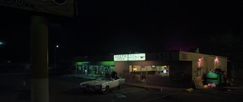 Movie still from “Fear and Loathing in Las Vegas” (1998), directed by Terry Gilliam – A car parked in front of a building at night; Extreme Wide shot, High angle