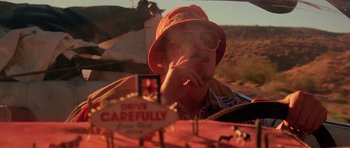 Movie still from “Fear and Loathing in Las Vegas” (1998), directed by Terry Gilliam – A man in a hat and sunglasses sitting in the driver's seat of a car; Close Up shot, Low angle