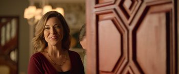 A woman standing in front of a wooden door