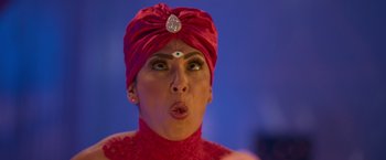 Movie still from “Fenced In” (2022), directed by Roberto Santucci – A woman in a red turban with her mouth wide open; Extreme Close Up shot, Over the shoulder angle