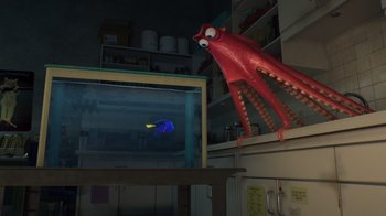 Movie still from “Finding Dory” (2016), directed by Angus MacLane – An octopus is flying over a fish in a fish tank; Wide shot, Over the shoulder angle
