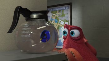 Movie still from “Finding Dory” (2016), directed by Angus MacLane – A fish bowl and a stuffed animal in front of a map; Medium shot, High angle