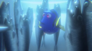 Movie still from “Finding Dory” (2016), directed by Angus MacLane – A blue fish swimming in the water surrounded by fish; Wide shot, Low angle