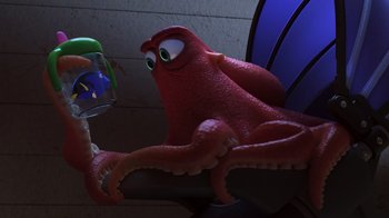 Movie still from “Finding Dory” (2016), directed by Angus MacLane – An octopus is sitting next to a little boy; Medium shot, Over the shoulder angle
