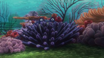 Movie still from “Finding Nemo” (2003), directed by Andrew Stanton – An underwater scene with a purple sea anemone and a coral; Wide shot, High angle