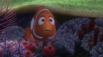 Movie still from “Finding Nemo” (2003), directed by Andrew Stanton – An orange fish is in the water near some coral; Medium shot, High angle