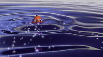 Movie still from “Finding Nemo” (2003), directed by Andrew Stanton – An orange fish swimming in a body of blue water; Extreme Wide shot, High angle