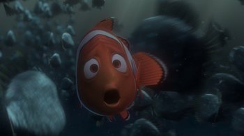 Movie still from “Finding Nemo” (2003), directed by Andrew Stanton – An orange and white clown fish in the water; Medium shot, High angle