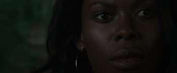 Movie still from “Firestarter” (2022), directed by Keith Thomas – A woman's face with dark skin; Extreme Close Up shot, Low angle