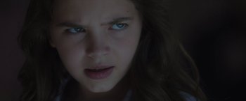 Movie still from “Firestarter” (2022), directed by Keith Thomas – A young girl's face with blue eyes; Close Up shot, Over the shoulder angle