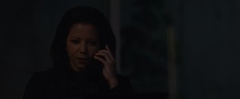 Movie still from “Firestarter” (2022), directed by Keith Thomas – A woman talking on a cell phone in the dark; Close Up shot, Over the shoulder angle
