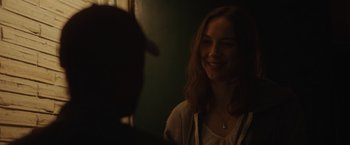 Movie still from “Firestarter” (2022), directed by Keith Thomas – A woman smiles at a man in a hat; Close Up shot, Over the shoulder angle