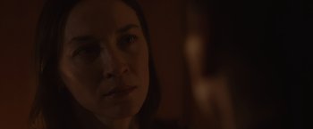 Movie still from “Firestarter” (2022), directed by Keith Thomas – A woman's face in the dark; Close Up shot, Over the shoulder angle