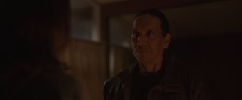 Movie still from “Firestarter” (2022), directed by Keith Thomas – A person wearing a brown jacket; Close Up shot, Over the shoulder angle