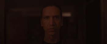 Movie still from “Firestarter” (2022), directed by Keith Thomas – A person's face in a dark room; Close Up shot, Low angle