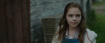 Movie still from “Firestarter” (2022), directed by Keith Thomas – A young girl is posing for a picture; Close Up shot, High angle