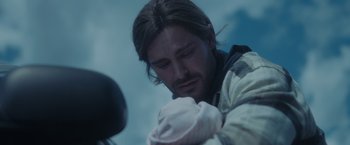 Movie still from “Firestarter” (2022), directed by Keith Thomas – A person holding a baby; Close Up shot, Over the shoulder angle