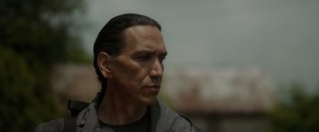 Movie still from “Firestarter” (2022), directed by Keith Thomas – A person wearing a black shirt; Close Up shot, Over the shoulder angle