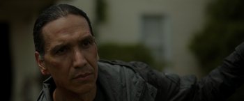 Movie still from “Firestarter” (2022), directed by Keith Thomas – A person wearing a black shirt; Close Up shot, Over the shoulder angle