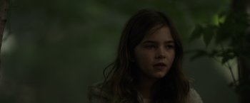 Movie still from “Firestarter” (2022), directed by Keith Thomas – A young girl with long brown hair stares into the distance; Close Up shot, Low angle