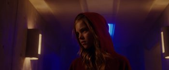Movie still from “Firestarter” (2022), directed by Keith Thomas – A young girl wearing a red hooded sweatshirt; Close Up shot, Low angle