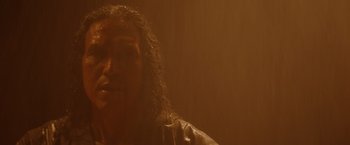 Movie still from “Firestarter” (2022), directed by Keith Thomas – A man with long hair is looking at the camera; Close Up shot, Low angle