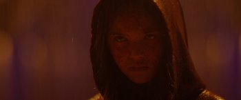 Movie still from “Firestarter” (2022), directed by Keith Thomas – A woman with long brown hair is looking at the camera; Close Up shot, Low angle