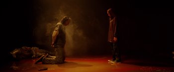 Movie still from “Firestarter” (2022), directed by Keith Thomas – Two men are standing in the middle of a stage; Wide shot, High angle