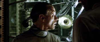 Movie still from “Alien: Resurrection” (1997), directed by Jean-Pierre Jeunet – A person wearing a suit and tie; Close Up shot, Low angle
