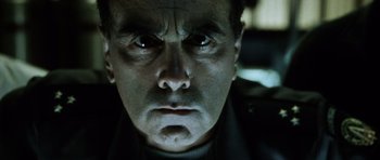 Movie still from “Alien: Resurrection” (1997), directed by Jean-Pierre Jeunet – A man's face in the dark; Close Up shot, Low angle