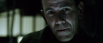 Movie still from “Alien: Resurrection” (1997), directed by Jean-Pierre Jeunet – A person looking at the camera; Close Up shot, Low angle