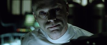 Movie still from “Alien: Resurrection” (1997), directed by Jean-Pierre Jeunet – A person wearing a white t - shirt; Close Up shot, Low angle