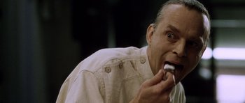 Movie still from “Alien: Resurrection” (1997), directed by Jean-Pierre Jeunet – A person eating a donut; Close Up shot, Overhead angle
