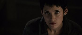 Movie still from “Alien: Resurrection” (1997), directed by Jean-Pierre Jeunet – A person with short black hair; Close Up shot, Low angle