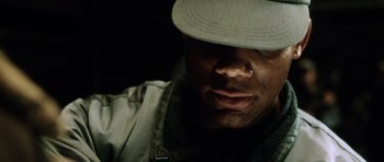 Movie still from “Alien: Resurrection” (1997), directed by Jean-Pierre Jeunet – A person wearing a hat; Extreme Close Up shot, Low angle