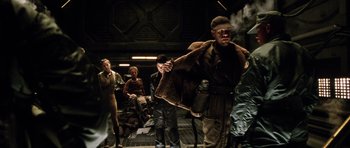 Movie still from “Alien: Resurrection” (1997), directed by Jean-Pierre Jeunet – A group of people standing next to each other in a room; Medium shot, High angle
