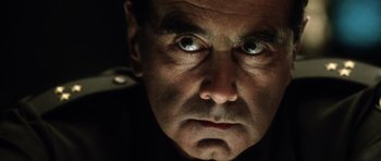 Movie still from “Alien: Resurrection” (1997), directed by Jean-Pierre Jeunet – A person's face with eyes wide open; Close Up shot, Low angle