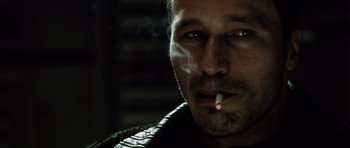 Movie still from “Alien: Resurrection” (1997), directed by Jean-Pierre Jeunet – A person smoking a cigarette; Close Up shot, Low angle
