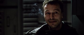 Movie still from “Alien: Resurrection” (1997), directed by Jean-Pierre Jeunet – A person smoking a cigarette; Close Up shot, Low angle