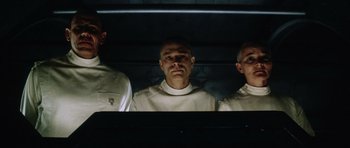 Movie still from “Alien: Resurrection” (1997), directed by Jean-Pierre Jeunet – A group of men standing next to each other in a room; Medium shot, Low angle