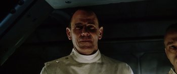 Movie still from “Alien: Resurrection” (1997), directed by Jean-Pierre Jeunet – A person wearing a uniform; Close Up shot, Low angle