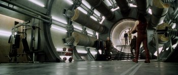 Movie still from “Alien: Resurrection” (1997), directed by Jean-Pierre Jeunet – Two men are walking down a set of stairs; Wide shot, High angle