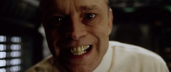 Movie still from “Alien: Resurrection” (1997), directed by Jean-Pierre Jeunet – A person's face with teeth; Extreme Close Up shot, Low angle