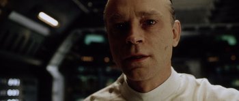 Movie still from “Alien: Resurrection” (1997), directed by Jean-Pierre Jeunet – A person wearing a white shirt; Close Up shot, Low angle