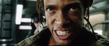 Movie still from “Alien: Resurrection” (1997), directed by Jean-Pierre Jeunet – A person with dreadlocks on; Extreme Close Up shot, Low angle