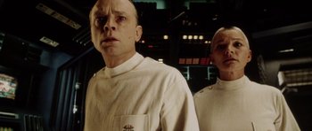 Movie still from “Alien: Resurrection” (1997), directed by Jean-Pierre Jeunet – A man and a woman standing next to each other; Close Up shot, Low angle