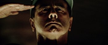 Movie still from “Alien: Resurrection” (1997), directed by Jean-Pierre Jeunet – A man's face with his hand touching his forehead; Extreme Close Up shot, Low angle