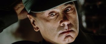 Movie still from “Alien: Resurrection” (1997), directed by Jean-Pierre Jeunet – A person wearing a hat; Extreme Close Up shot, Low angle