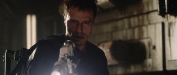 Movie still from “Alien: Resurrection” (1997), directed by Jean-Pierre Jeunet – A person holding a camera in a dark room; Close Up shot, Low angle