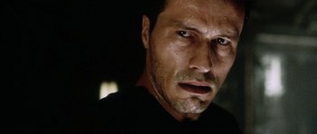 Movie still from “Alien: Resurrection” (1997), directed by Jean-Pierre Jeunet – A man's face in the dark; Close Up shot, Low angle